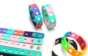 Colorful silicone wristband with metal snap buttons and holes, stylish unisex bracelet.