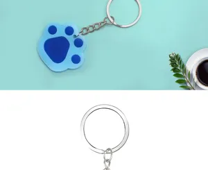 Cute blue paw print keychain for pet lovers, durable metal ring and charming pendant design.