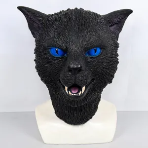 Close-up detail of black cat mask with blue eyes and sharp teeth for party props.