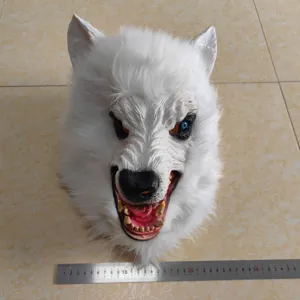 Detailed shot of a white latex and plush werewolf mask with realistic scary teeth for Halloween.
