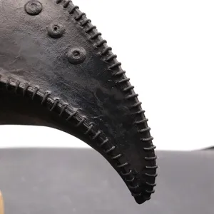 Close up of a black steampunk plague doctor mask beak with detailed stitching and rivet accents.