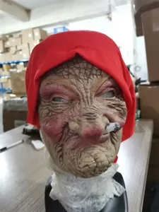 Detailed view of the creepy Halloween old lady latex mask with red hood and realistic wrinkles.