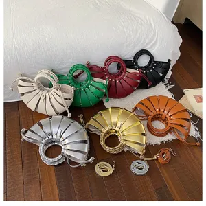 Detailansicht verschiedener modischer Plissee-Muschelhandtaschen in leuchtenden Trendfarben.