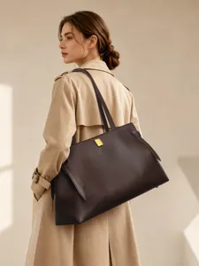 Detailed view of large capacity brown leather tote bag, perfect for daily commute use.
