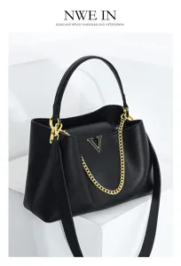 Elegant black leather handbag with gold chain and metal V logo, perfect for daily commute.