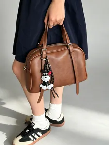Brown soft leather handbag for women, versatile casual boston bag with cute dog charm detail.
