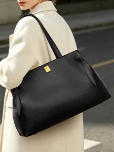 Classic black leather tote bag for women, stylish large capacity shoulder bag for daily commute.