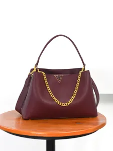 Women's burgundy leather handbag with gold chain and V-logo for daily commuting.