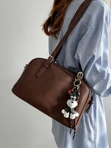 Brown leather shoulder bag for women, casual boston handbag with cute dog charm and strap.