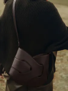 Brown leather shoulder bag detail, unique cutout crossbody design, premium fashion accessory.