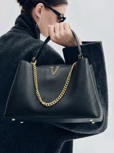Elegant black leather handbag with striking gold chain and V logo for women chic daily commute.