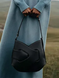 Stylish black shoulder bag for women, modern knot design, large capacity crossbody bag.