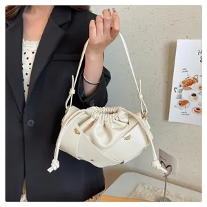 Fashion white PU leather shoulder bag, trendy woven cloud bag with stylish drawstring design.