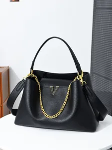 Stylish black leather tote bag for women, large capacity shoulder handbag with gold chain.
