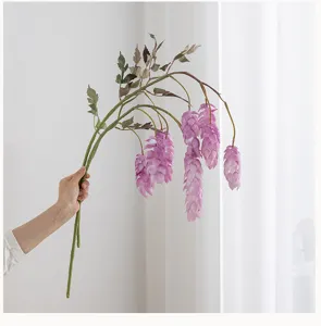 Detailed view of artificial hops branch with cascading purple flower heads, soft home decor.