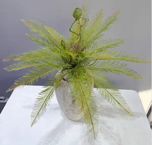 Detailed shot of artificial fern plant in ceramic pot, perfect for home and office decor.