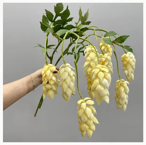Artificial hop flower hanging decoration detail view, realistic soft rubber plant garland.
