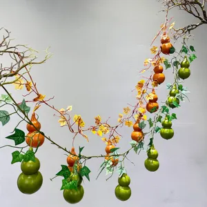 Detailed view of artificial gourd vine with green and orange gourds for hanging decor.