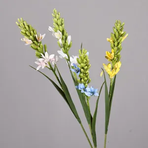Dettaglio di fiori artificiali, boccioli multicolori e foglie verdi per decorazioni.