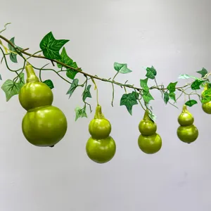 Artificial gourd vine hanging plant detail showing lush green leaves and realistic gourds.