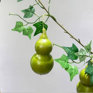 Artificial gourd vine detail showing realistic green leaves and smooth double-bulb fruit pendant.