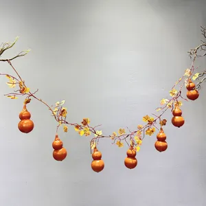 Artificial gourd vine hanging decoration with realistic pumpkins and maple leaves for decor.