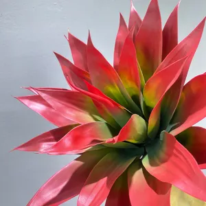 Closeup of vibrant red and green artificial agave plant leaf, perfect for home decor detailing.