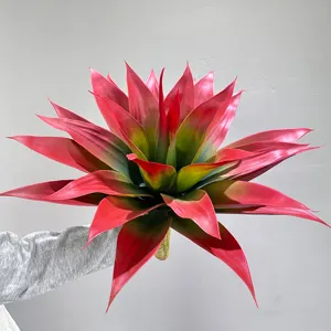Close-up detail shot showing realistic red and green gradient artificial agave plant leaves.
