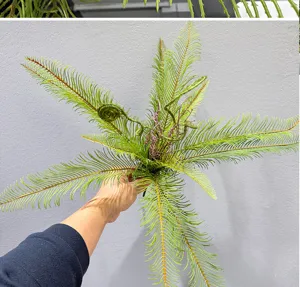 Detailed view of artificial fern plant, realistic green foliage for home indoor decor.