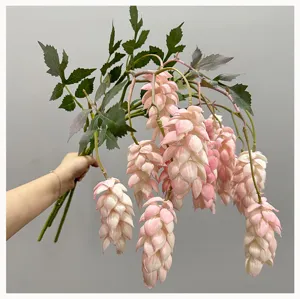 Close-up shot showing the detailed texture and hanging form of the artificial pink hop flower branch.
