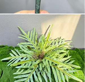 Artificial fern plant detail shot showing realistic green foliage and texture for home decor.