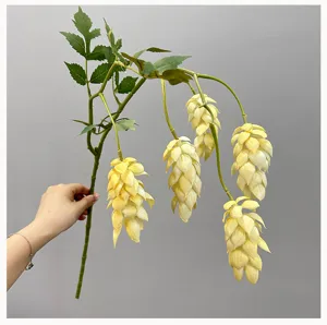 Detailed view of artificial hops flower branch with green leaves, perfect for home decor.