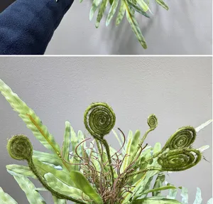 Close-up detail shot of artificial fern fronds and green plant arrangement for home decor.