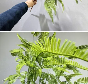 Artificial fern leaf detail shot, realistic green plant branch for indoor home decor and space design.