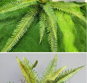 Artificial fern leaves and moss mat faux plant green decor for home landscaping design.
