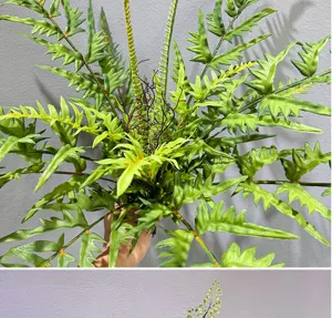 Close-up detail of artificial fern leaves bunch fake green plants for home decor display.