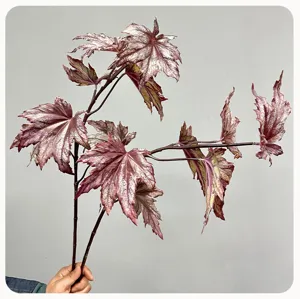 Artificial plant detail shot showing purple silver foliage stem for home floral decor.