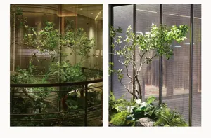 Detailed view of artificial green plant wall and potted terminalia leaves for indoor decor.
