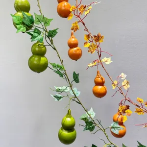 Artificial gourd vine hanging decoration, fake plant greenery for home wall decor and design.