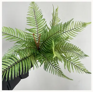 Detailed view of artificial fern leaf, realistic green boston fern branch for home decor.