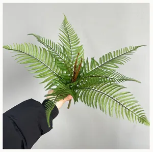Artificial fern plant detail view, realistic green foliage branch for home decor and floral design.