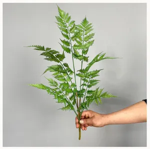 Artificial Boston fern leaves closeup, green foliage for decor and floral design.