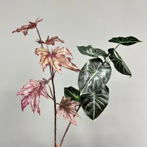 Artificial Alocasia plant stems fake green foliage leaves for home indoor floral decor setup.