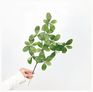 Artificial green plant branch detail shot, realistic leaf texture, perfect for home decor display.
