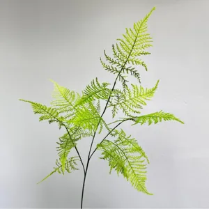 Artificial fern branch green plant for home decor, floral arrangement and interior landscaping.