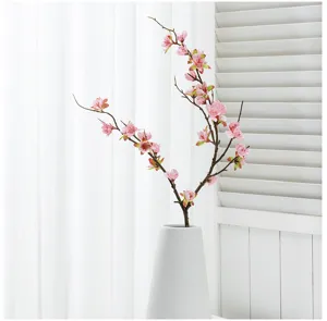 Artificial peach blossom branch detail shot, beautiful pink floral arrangement for home decor.