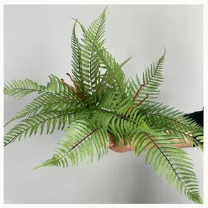 Artificial fern frond detail, realistic green foliage for micro landscape floral arrangement.