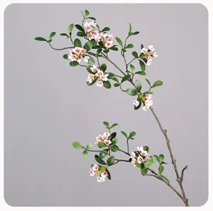 Artificial flower branch with green leaves and pink blossoms for home decor and styling.