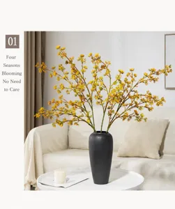 Artificial berry flower branch in black ceramic vase, Nordic home decor detail shot.