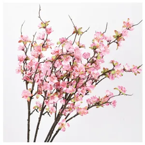 Detail view of artificial pink peach blossom branches, great for home decor and photography props.